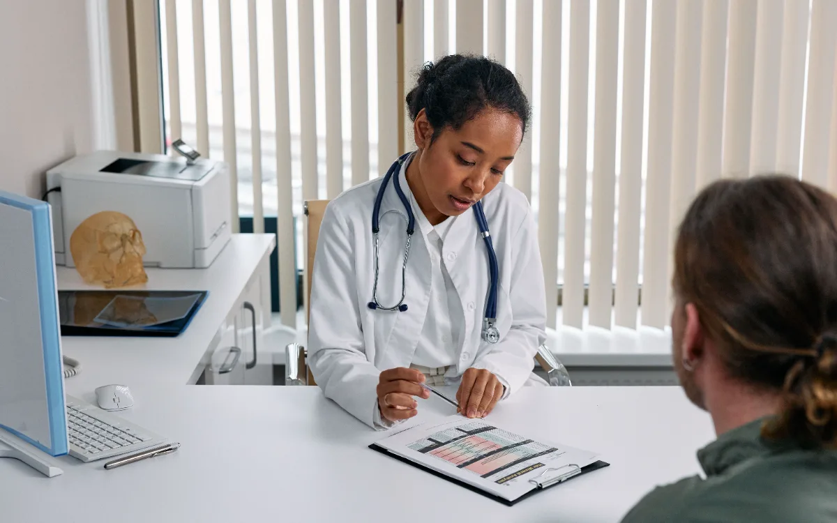 Doctor reviewing a patient's report together at her desk