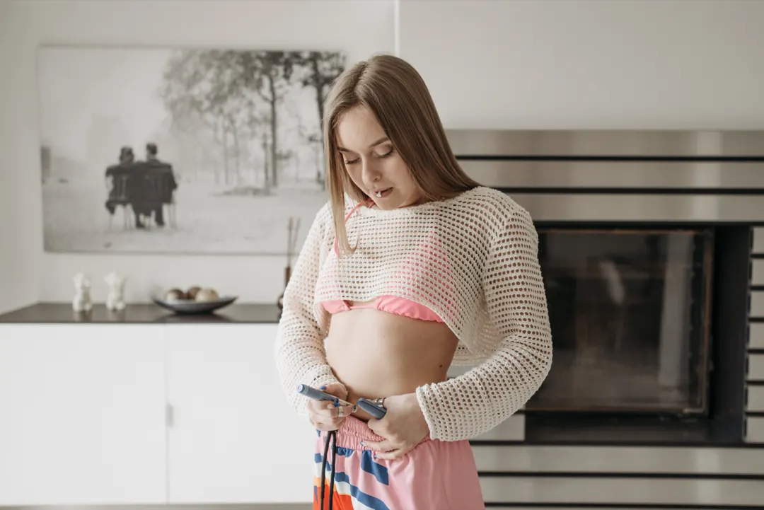 Woman administering a GLP-1 injection pen at home